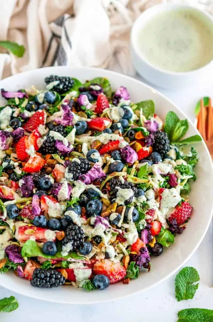 Superfood berry salad with creamy lemon herb dressing served in a bowl