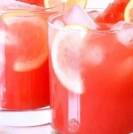 Refreshing watermelon lemonade served in a glass with a slice of lemon