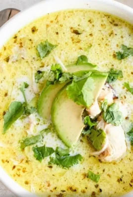A bowl of creamy white chicken chili garnished with cilantro and jalapenos.