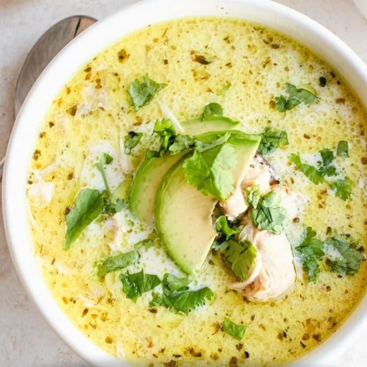 A bowl of creamy white chicken chili garnished with cilantro and jalapenos.